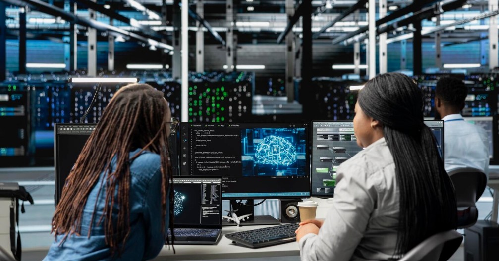 Young women learning data, cloud and digital infrastructure skills
